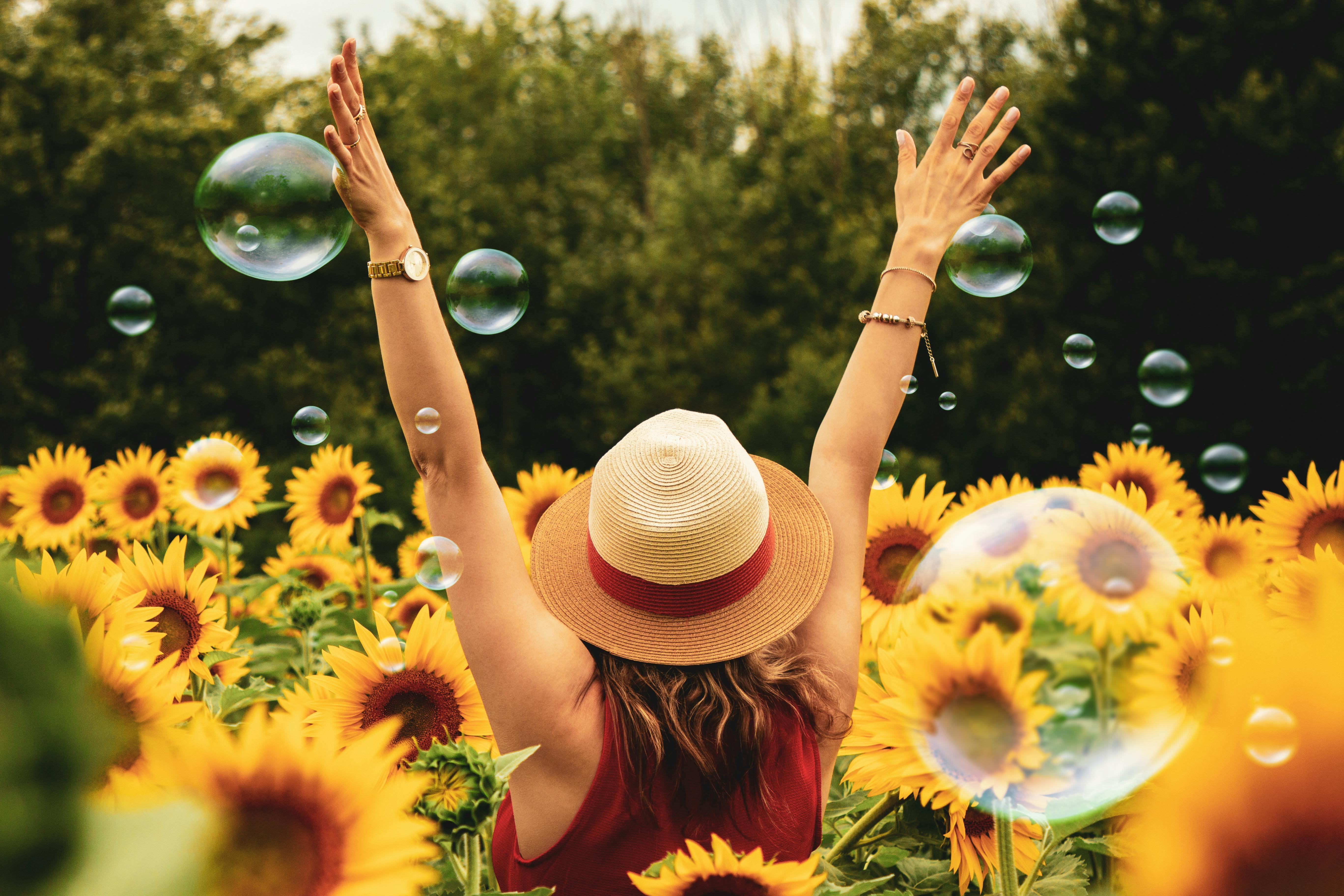 Happy girl in field of flowers